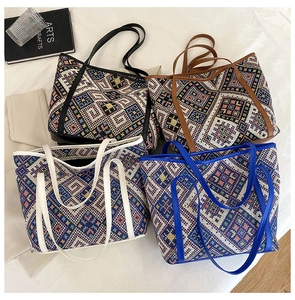 Detailed top view of four ethnic tote bags with geometric weave and leather handles