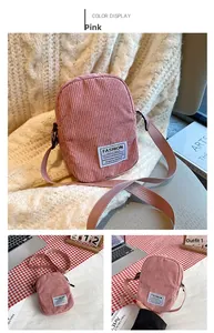Detailed view of pink corduroy mini crossbody bag with square fabric label and strap