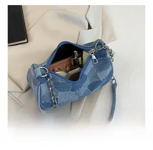 Internal view of blue patchwork denim bag showing capacity for cosmetics and accessories