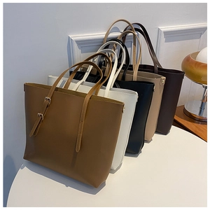 Close-up of five colorful textured faux leather tote bags in a minimalist home setting