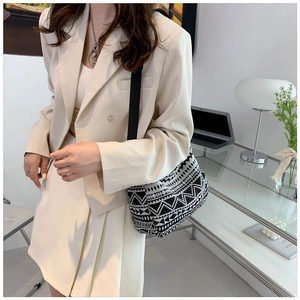 Ethnic geometric pattern crossbody bag shown with chic outfit in modern office setting