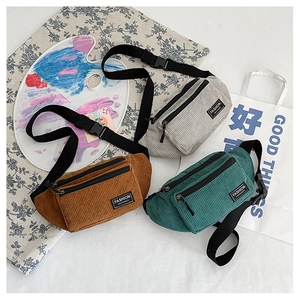 Close-up of corduroy waist bags in brown, beige and green with adjustable nylon straps