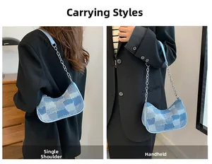 Detail of blue patchwork denim baguette bag with silver chain and leather strap
