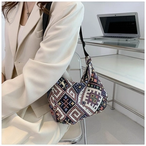 Close-up of ethnic geometric woven bag with colorful jacquard patterns and adjustable strap