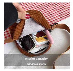 Detail showing internal capacity and mesh pocket of the brown corduroy crossbody bag