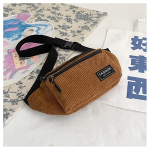 Close-up of caramel corduroy waist bag showing vertical texture and adjustable strap