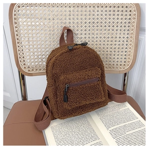 Detailed view of the brown teddy fleece material and zipper on the mini backpack