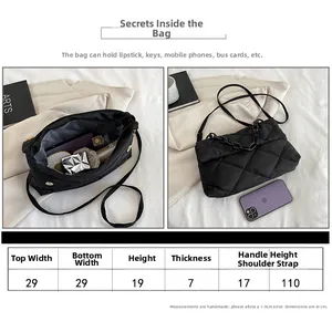 Detailed size chart for black quilted nylon chain bag with internal capacity view
