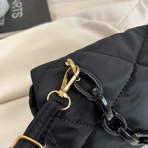Chic black quilted nylon shoulder bag with chunky resin chain and gold hardware detail
