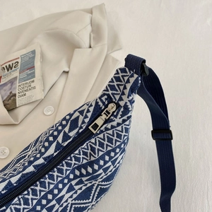 Ethnic style woven crossbody bag with geometric patterns and blue nylon strap