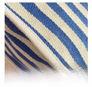 Macro shot of precise stitching and blue-white striped woven canvas fabric texture