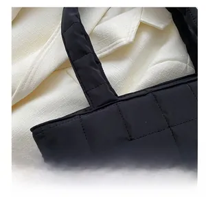 Close-up of black quilted tote bag showing high-quality stitching and nylon fabric texture