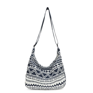 Ethnic knit moon bag in blue and white geometric patterns with crossbody strap