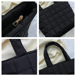 Macro details of black quilted tote bag showing golden zipper and durable stitching