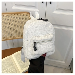 Handheld mini faux shearling backpack in white with adjustable straps and front pocket
