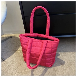 Detailed close-up of vibrant rose pink quilted nylon tote bag showing stitching quality