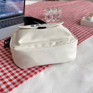 Minimalist creamy white nylon crossbody bag with dance print and adjustable strap
