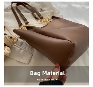 Detail showing high-quality PU leather material with chic plush bear pendant accessory