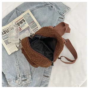 Detailed interior view of a brown lamb wool mini backpack with zipper and adjustable strap