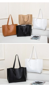 Minimalist large-capacity tote bags in various colors displayed on a white stand