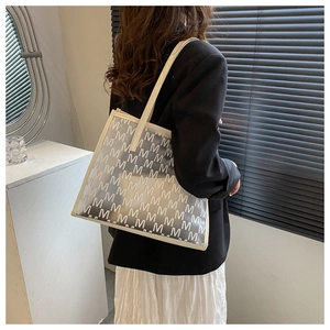 Detail of minimalist translucent tote bag with M letter print and leather piping