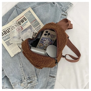 Close-up of brown teddy fleece mini backpack interior showing storage for phone and accessories