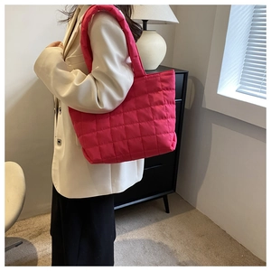 Detail of rose red quilted tote bag showing high-capacity design and nylon texture