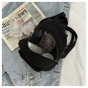 Detailed view of mini faux shearling backpack showing internal storage for daily essentials