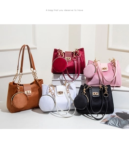 Detail showing five colors of velvet tote bags with gold chains and mini round purses