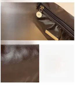Detail view of smooth dark brown leather texture with neat stitching and metal zipper