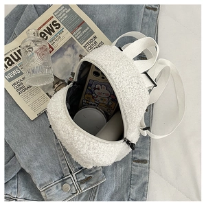 Mini white fuzzy lamb wool backpack with interior storage showing a phone case and cosmetics