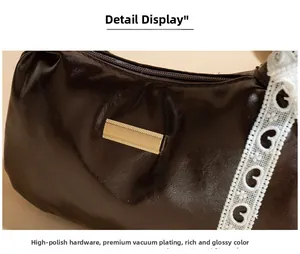 Detail of soft PU leather bag featuring polished gold hardware and white lace trim