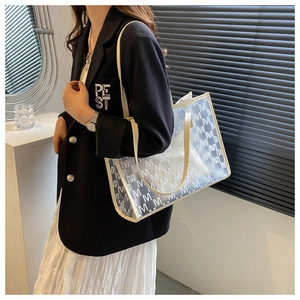 Chic semi-transparent tote bag with repeating M pattern and slim leather handles