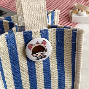 Blue and white striped canvas tote bag with a cute cartoon badge for casual shopping