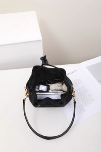 Top view of black matte drawstring bucket bag showing large interior storage capacity