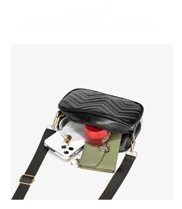Detail view of black quilted crossbody bag showing storage capacity for daily essentials