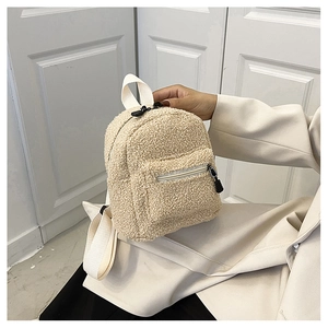 Handheld teddy fleece mini backpack in beige showing plush texture and small front pocket