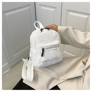 Detailed view of soft white sherpa fleece texture on a mini backpack for winter