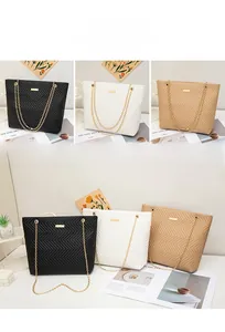 Quilted tote bags in black, white, and apricot with wave embroidery and gold chain details
