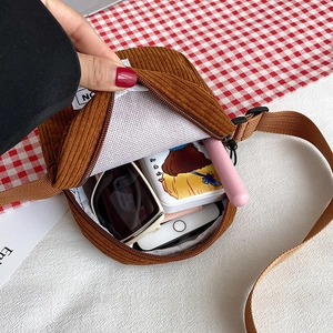 Caramel brown corduroy crossbody bag with front mesh pocket showing storage capacity