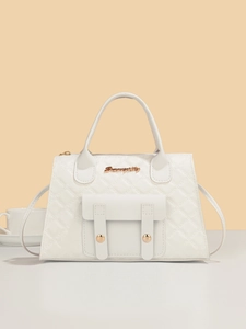 Detailed view of white quilted handbag featuring gold hardware and elegant diamond patterns