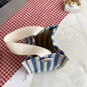 Minimalist blue and white striped canvas tote bag with stylish round cartoon button