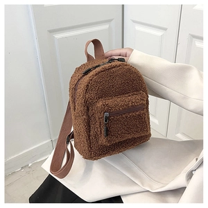 Close-up of brown faux shearling mini backpack with nylon straps and zipper details