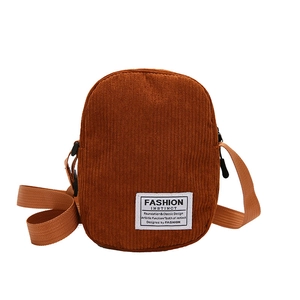 Caramel corduroy crossbody bag with adjustable strap and fashion instinct label
