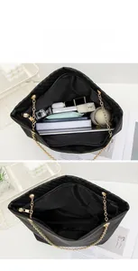 Black quilted tote bag with chain strap showing spacious interior and large capacity