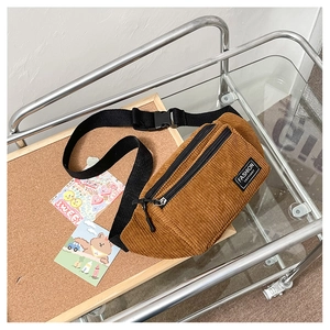 Close-up of retro corduroy waist bag with double zippers and fashion fabric label