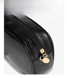 Detail of black PU leather bag with gold zipper and durable double stitching