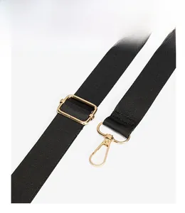 Detail of adjustable black strap with premium matte gold hardware and lobster clasp hook