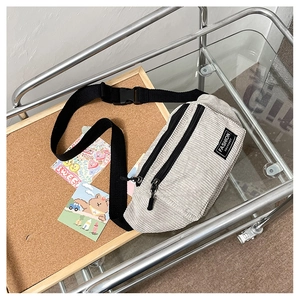 Detail of cream corduroy waist bag showing texture and Fashion Instinct woven label
