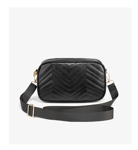 Close-up of black chevron quilted crossbody bag with golden hardware and wide fabric strap
